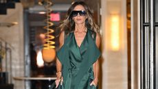 Victoria Beckham in a green dress leaving a modern NYC building in 2022