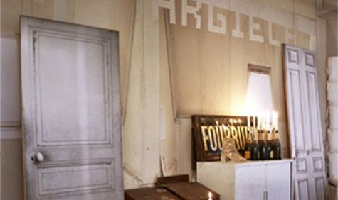 Room decorated with candles and wine bottles