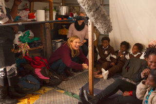 Diane Kruger laughs during a talk with a group of school girls.