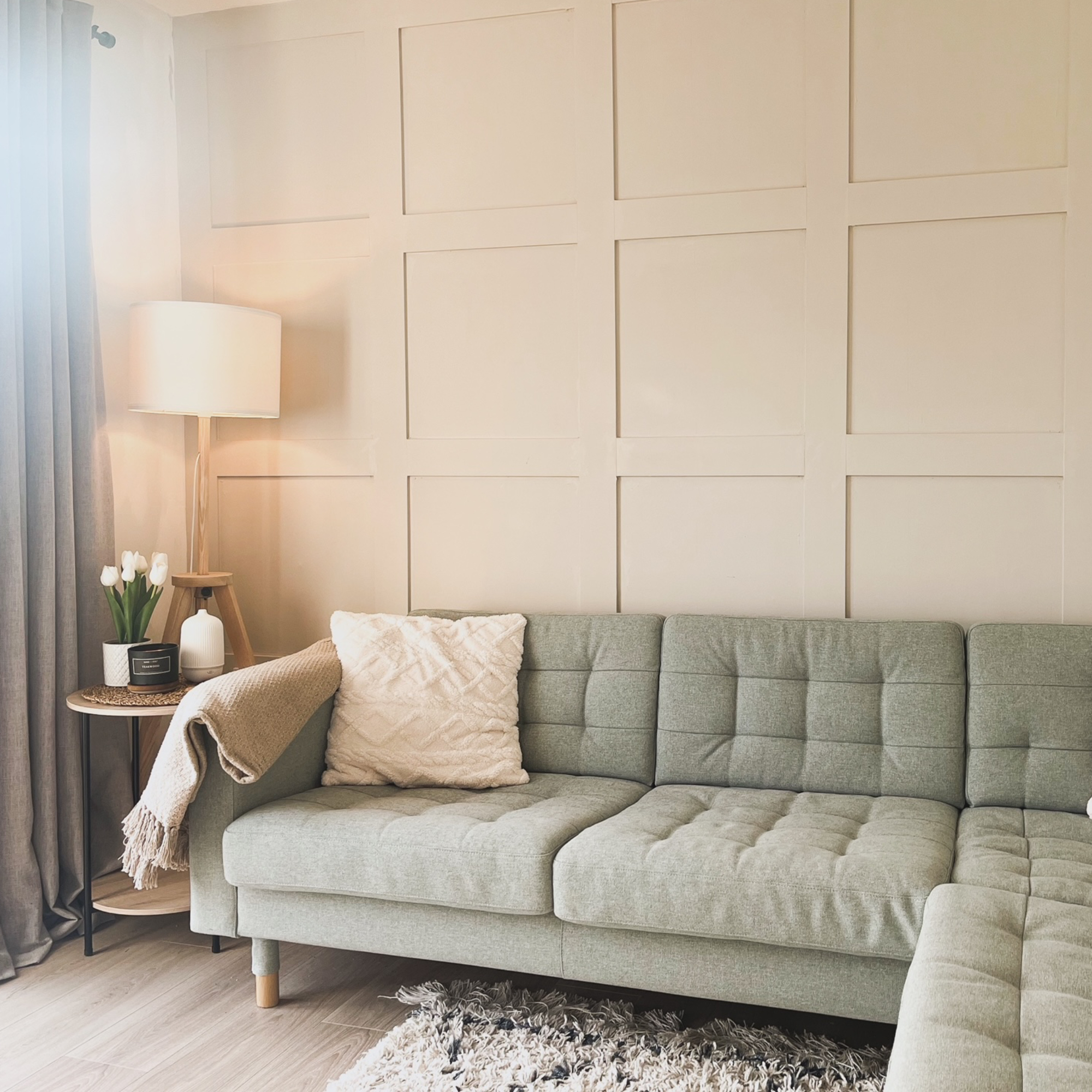 living room with green sofa and wall panelling