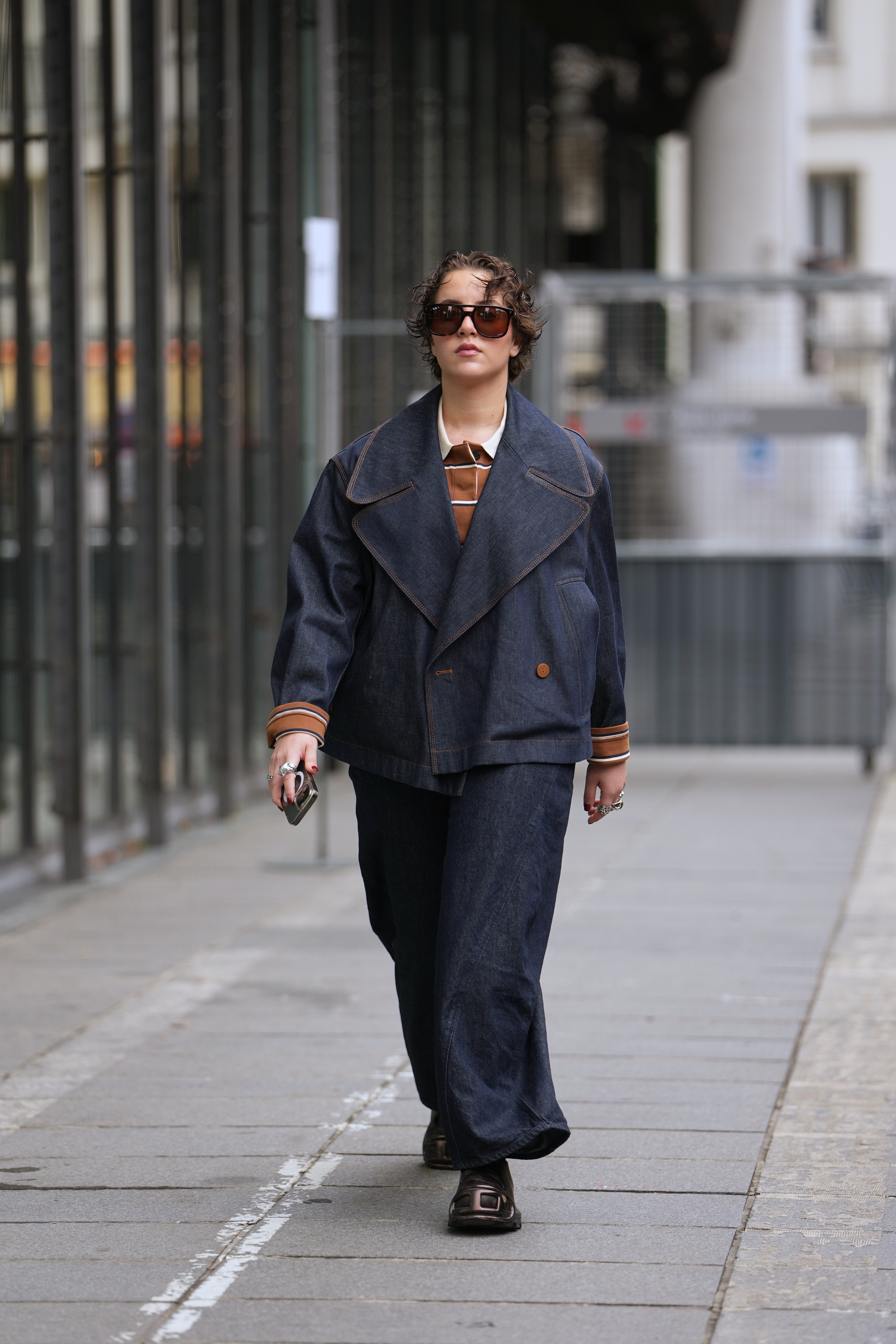 Person wearing a denim jacket during Paris Fashion Week.