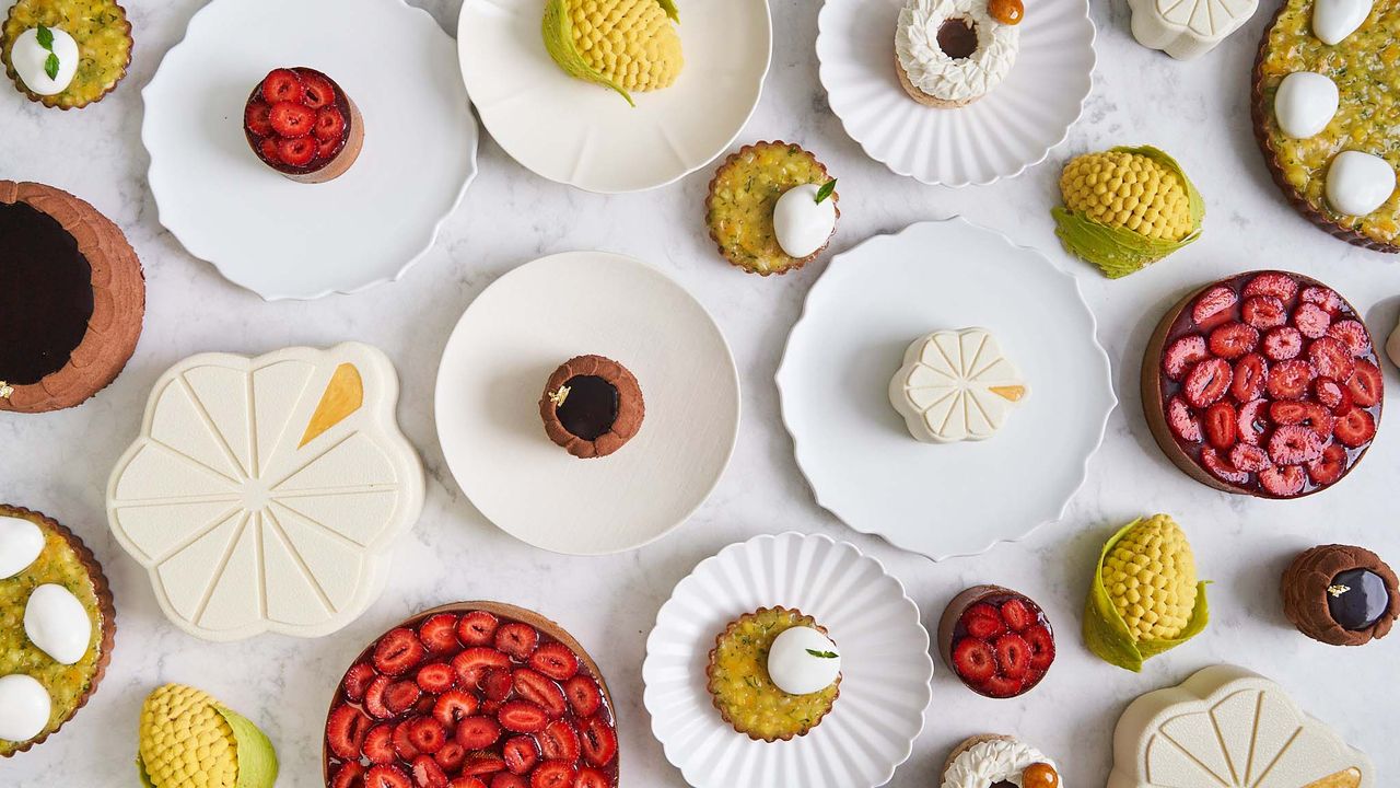 Lysée New York pastry shop&#039;s cakes on big white plates, from above