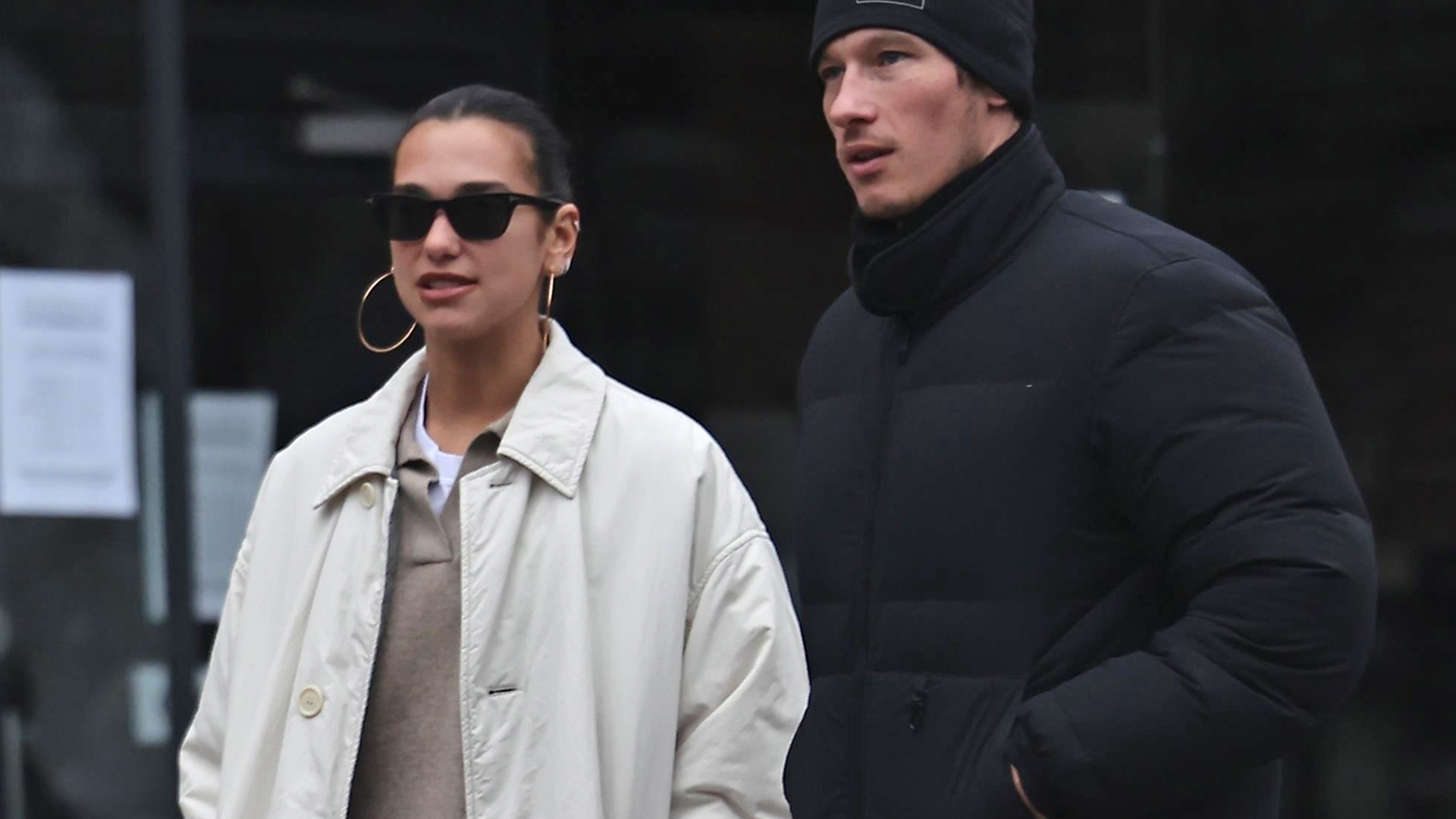 Dua Lipa was spotted in London wearing a khaki trench coat, a polo sweater, and statement Moon Boots