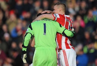 Asmir Begovic (L) of Stoke City is congratulated by team-mate Ryan Shawcross after scoring the opening goal during the Barclays Premier League match between Stoke City and Southampton on November 02, 2013 in Stoke on Trent, England.