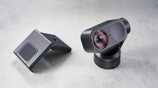 a photograph of a small grey 4K webcam with a gimbal and PTZ functionality