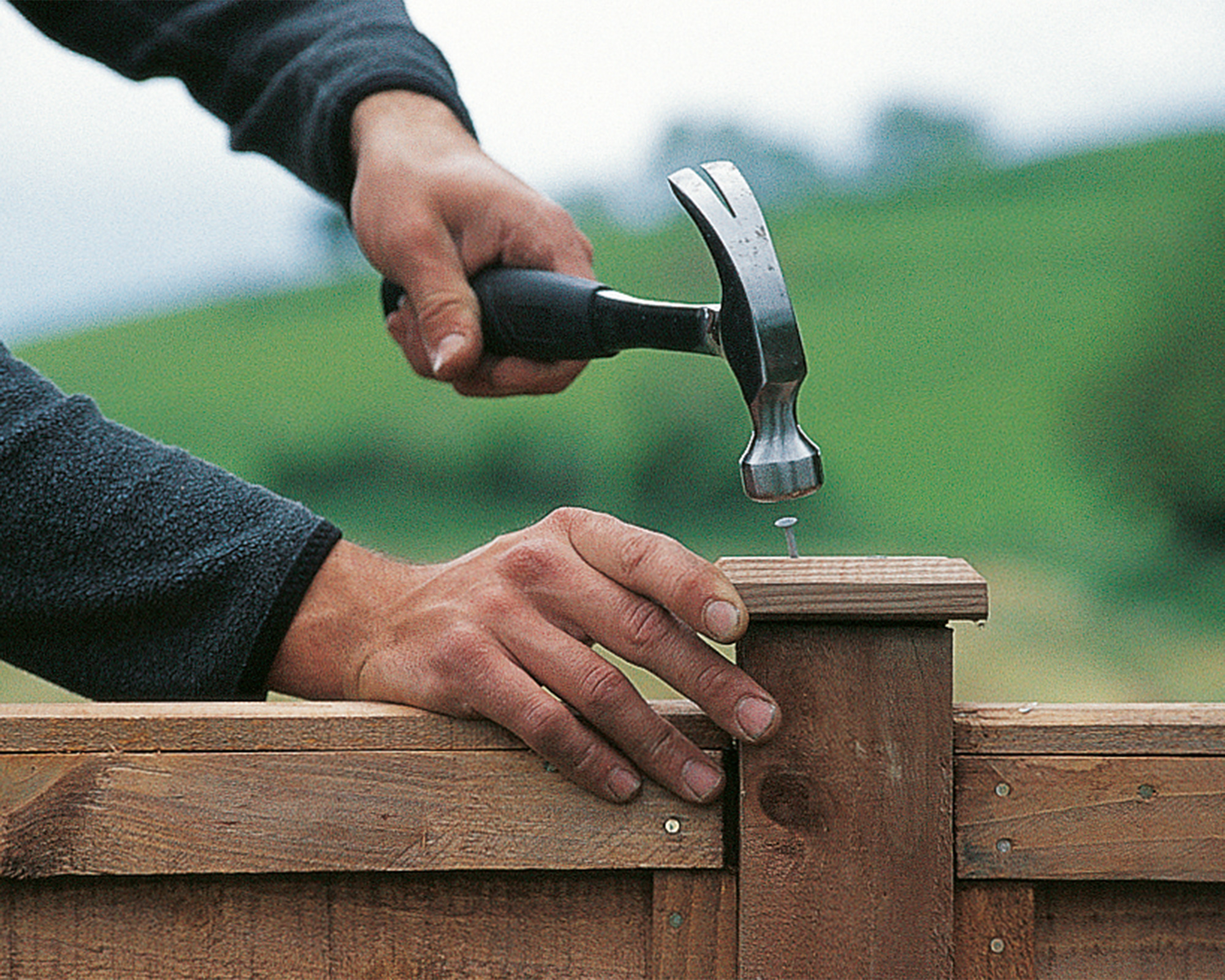 fitting a post cap onto a new fence post to prevent rot