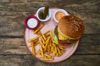 Image of a burger and chips on a plate