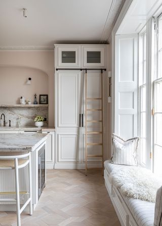 White kitchen with floor-to-ceiling storage and ladder