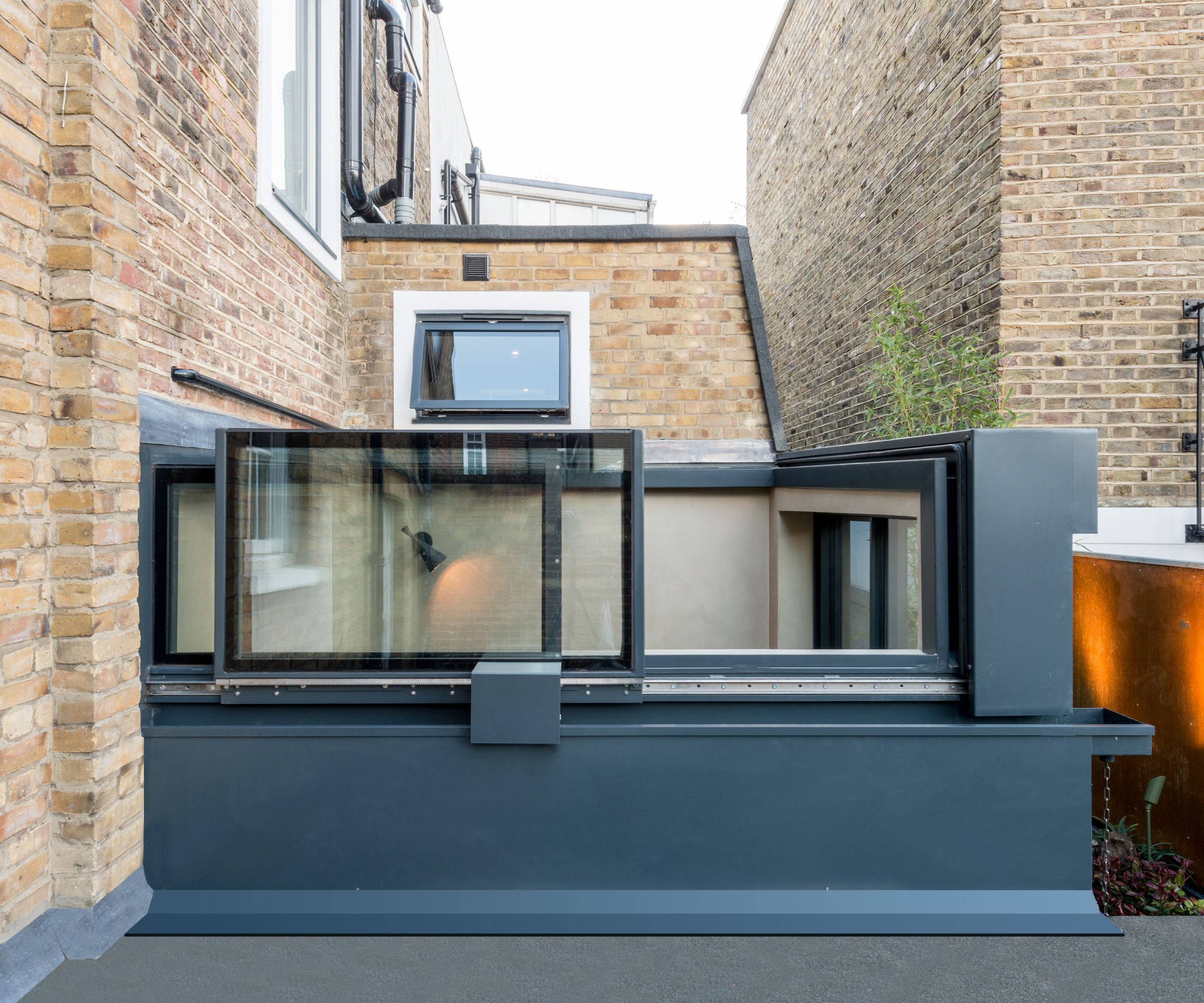 opening glass roof on extension nestled in between two properties