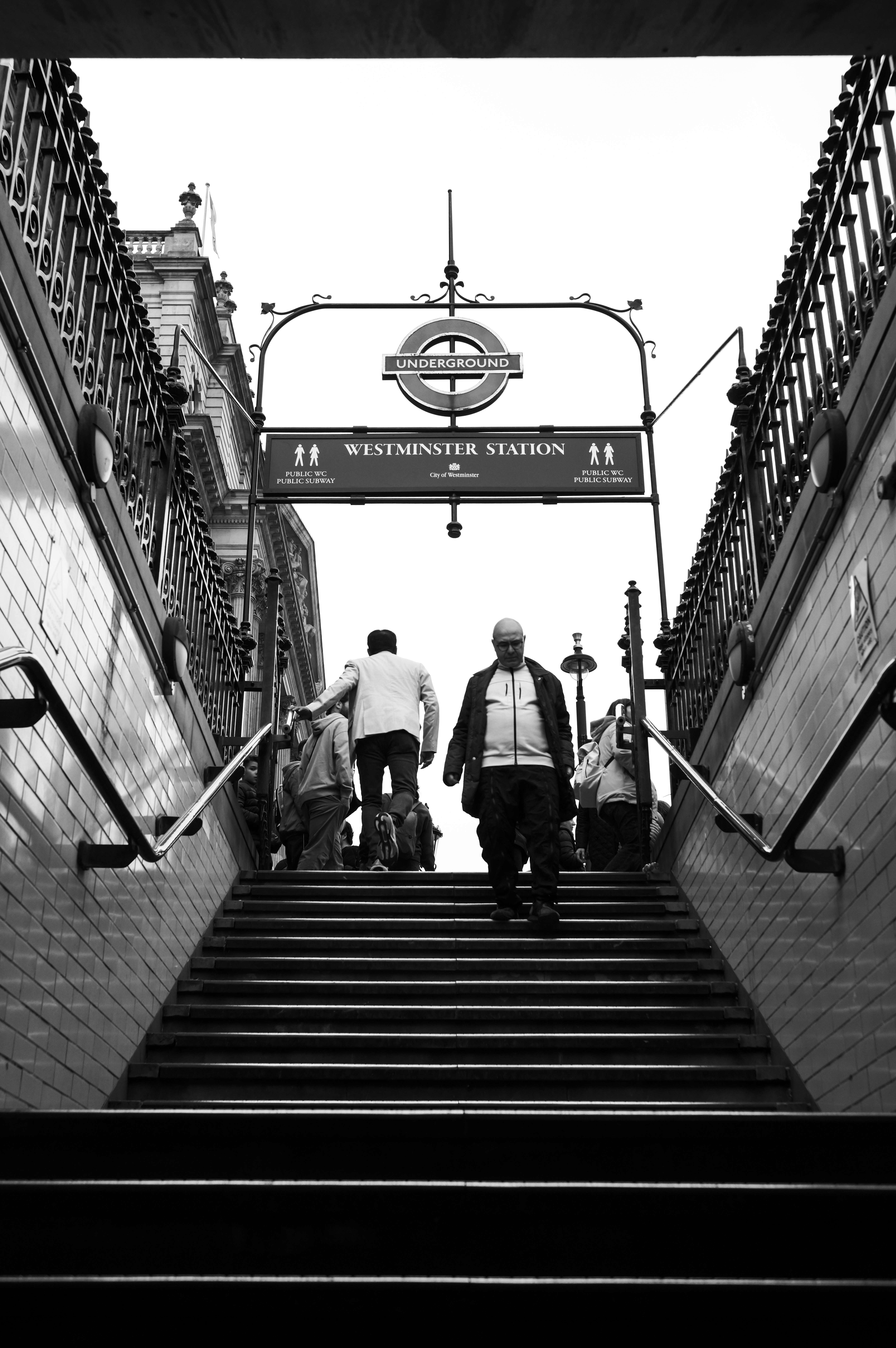 People walking up and down the steps at Westminster underground station