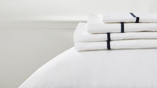 White Company bed sheets folded on bed