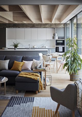 an open plan living space with the kitchen beyond