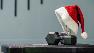 Dumbbells with Santa hat perched on one dumbbell