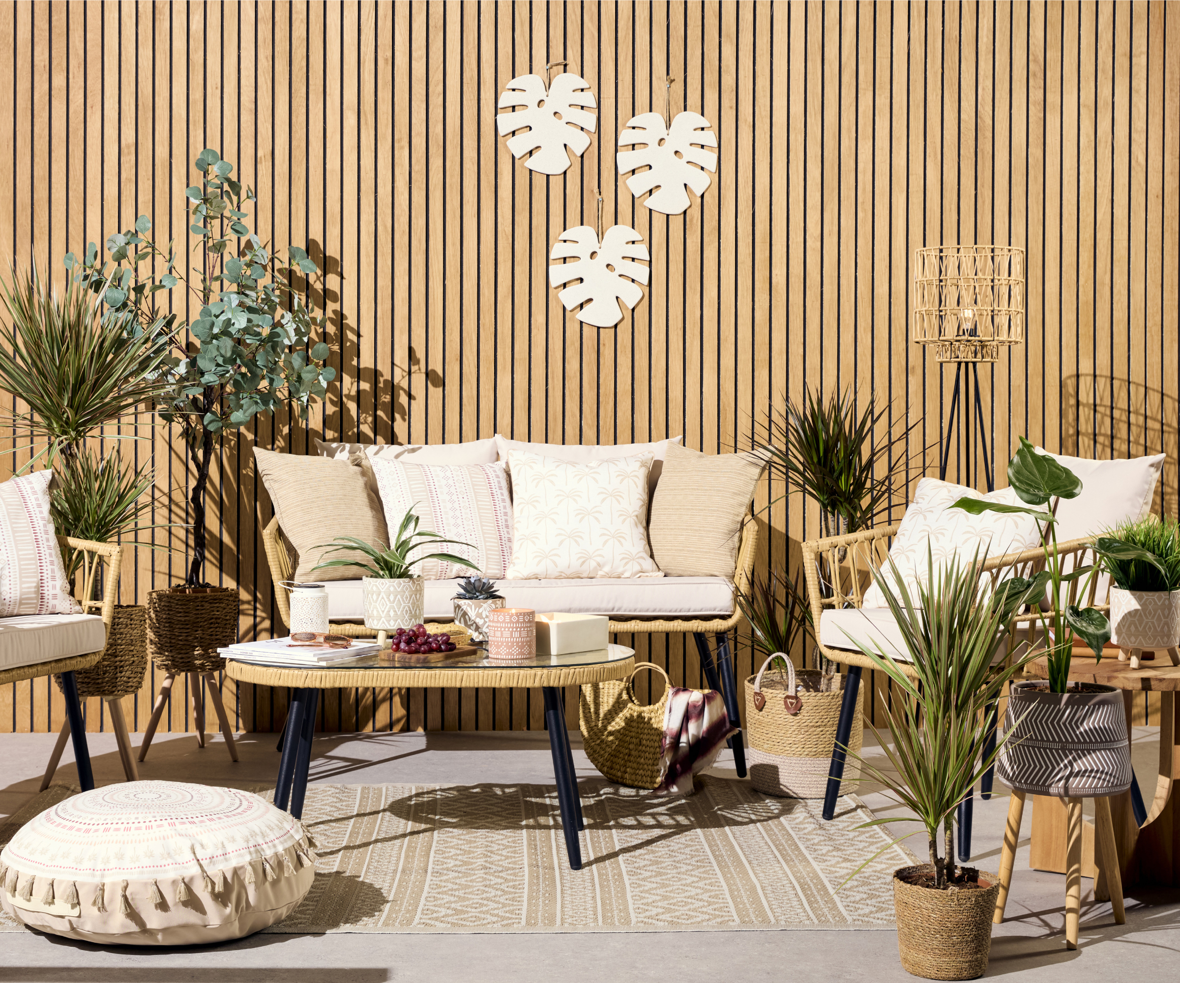 light vertical thin slatted fence with wicker and metal furniture on patio