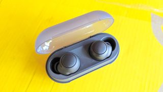 Listing image for best cheap wireless earbuds showing the Sony WF-C500 wireless earbuds sitting in their charging case