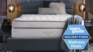  Image shows the Saatva Classic luxury innerspring hybrid mattress on a grey bedframe bookended by two brass pelmet lights