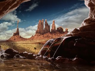 A screen at the Arte Museum of Las Vegas showing a desert landscape and a native's blanket