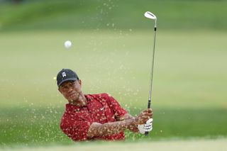 Tiger Woods plays his fourth shot on the seventh hole during the final round of The Memorial Tournament on July 19, 2020 at Muirfield Village Golf Club in Dublin, Ohio.