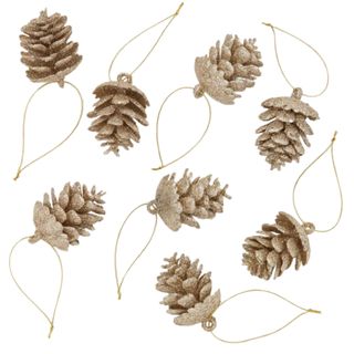 Seven gold pinecones with gold string looped onto them