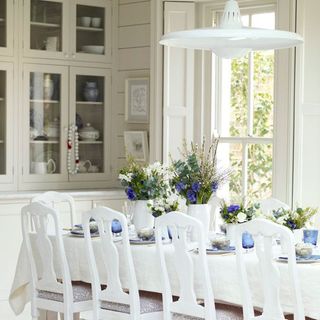 dining room with white chair and flower vase