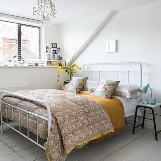 bedroom with white walls and wooden flooring