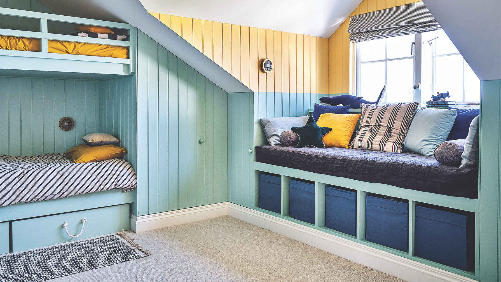 childrens bedroom with mint and yellow panelled walls and window seat with box storage beneath it