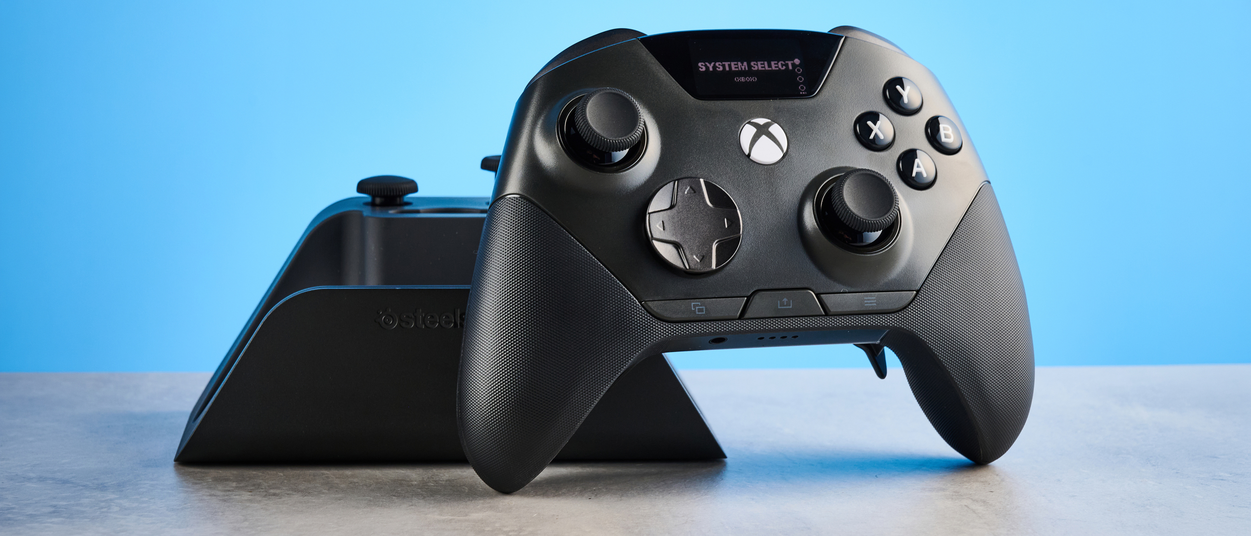 The SteelSeries Aeon Pro on a stone surface against a blue background