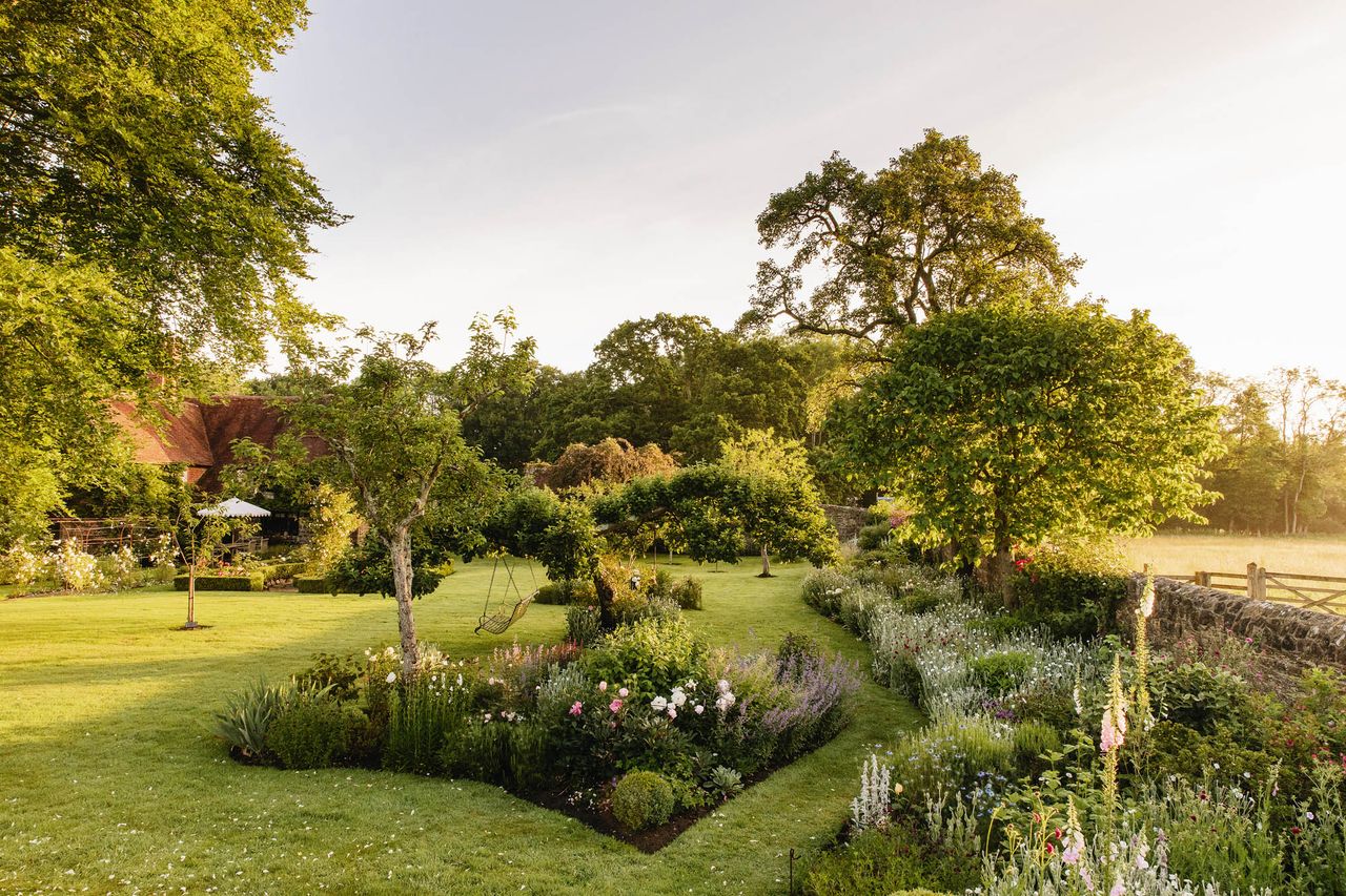 The swing seat hanging from a cooking-apple tree was made by a friend and given as a present by Harriet Anstruther to her husband, Henry Bourne — Harriet Anstruther&#039;s garden in West Sussex. ©Eva Nemeth