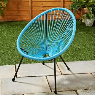 light blue moon chair in garden area with lawn
