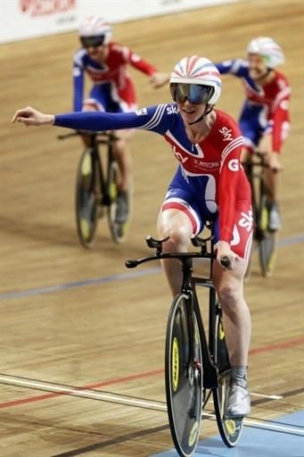 Britain's Wendy Houvenaghel followed by teammates Laura Trot and Danielle King celebrates after winning the team pursuit