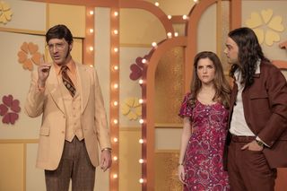 anna kendrick as a contestant on the dating game standing by the show's host and her date in a still from the movie woman of the hour