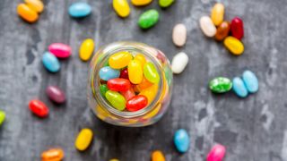 image from above of a jar of colourful jellybeans as part of Easter games to play