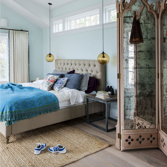attic bedroom with blue walls and wooden flooring