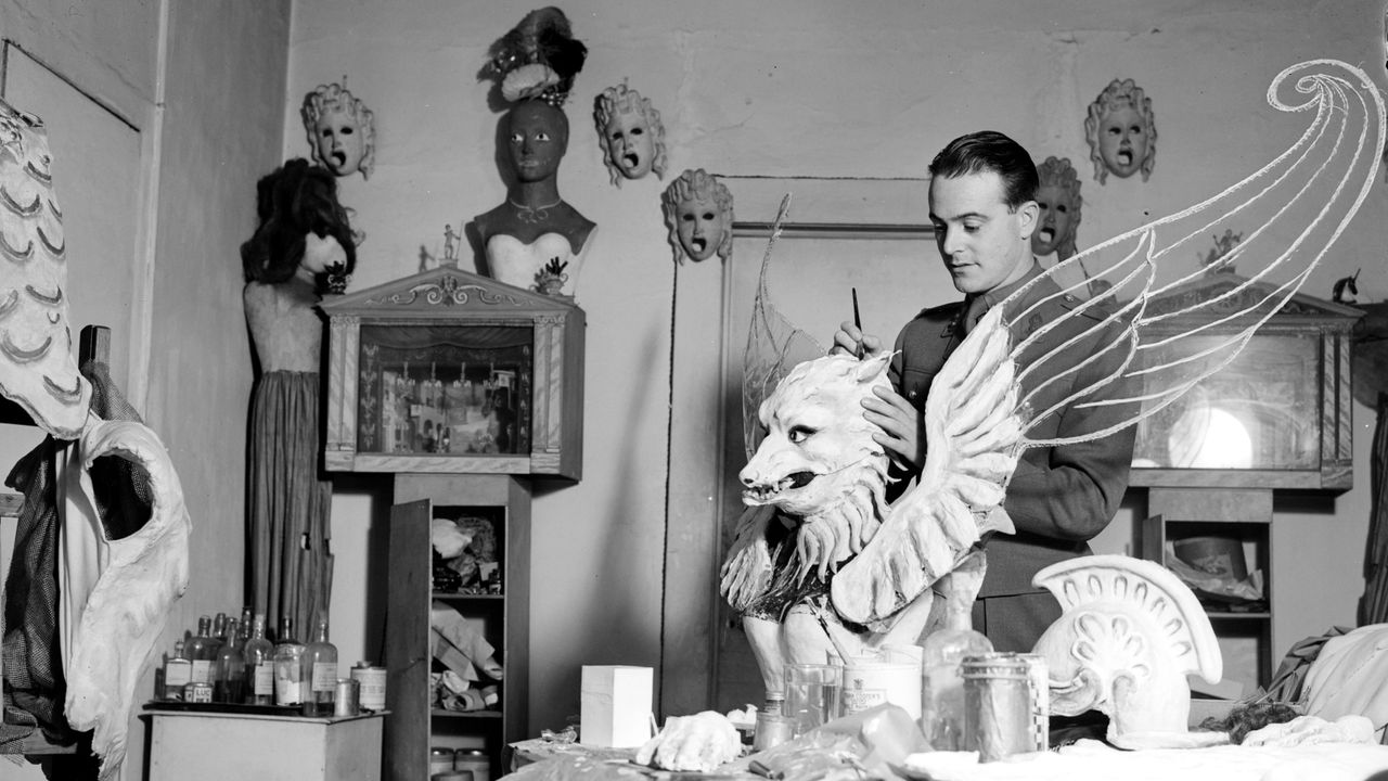 Black and white picture of a man painting stage props