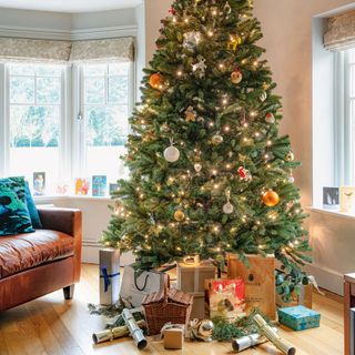sitting area with christmas tree and wooden floor