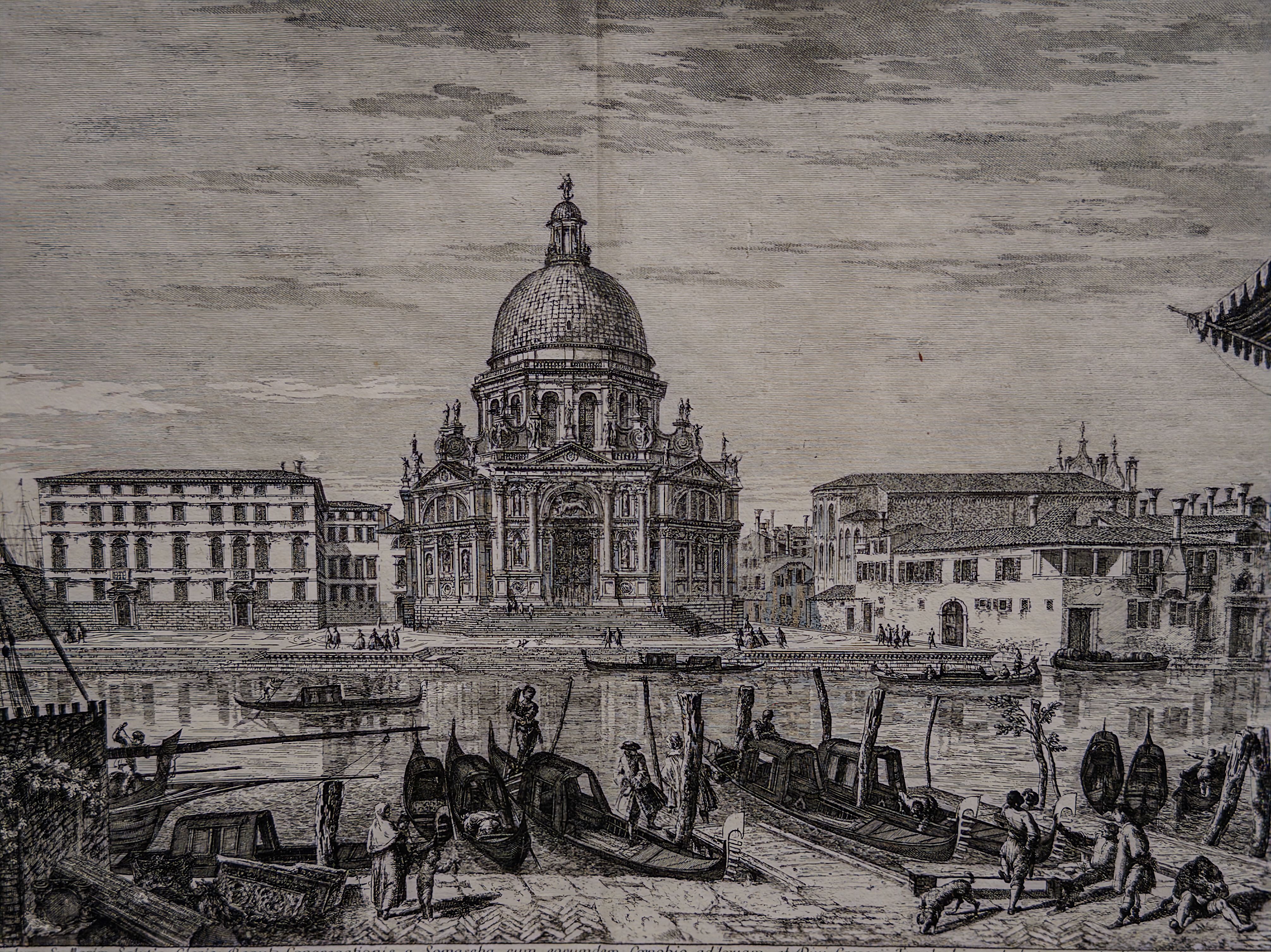 Historic black-and-white engraving of a domed Venetian church beside a canal filled with boats and figures.