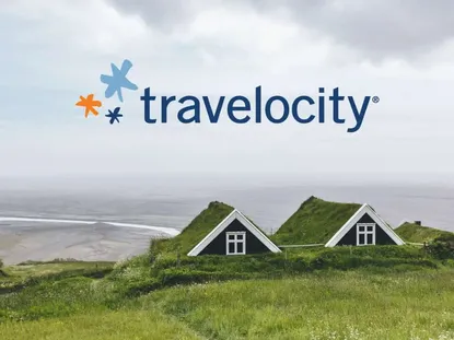 The travelocity logo above two eco-cabins with grass roofs on the coast