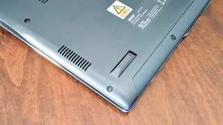 Closeup of Acer Swift 14 AI's bottom speaker and rubber footpad.