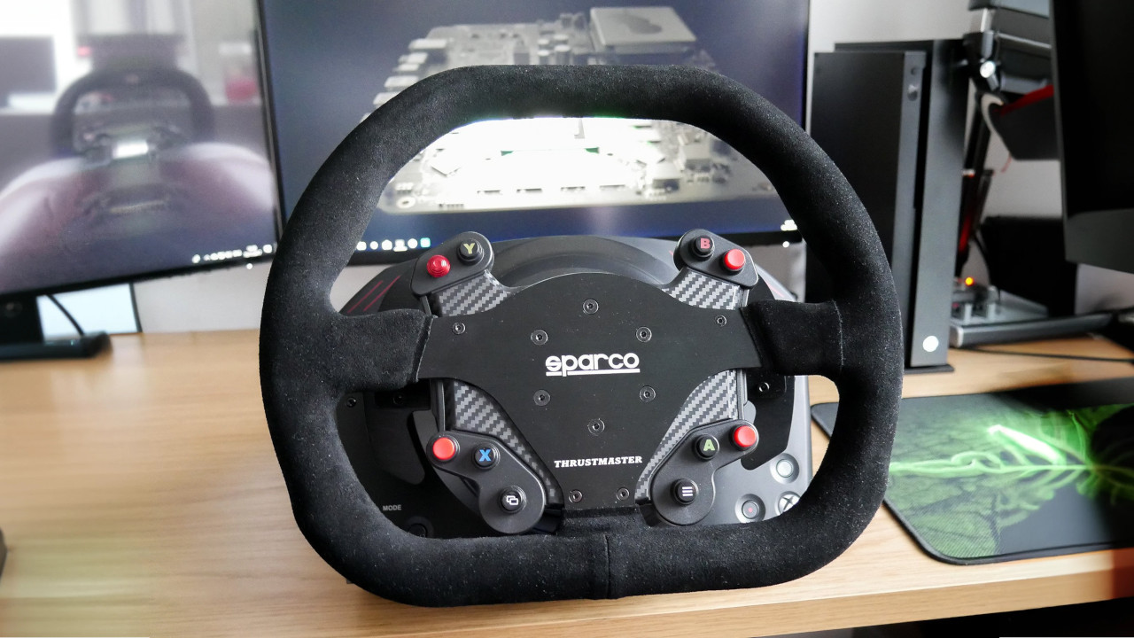 Thrustmaster TS-XW racing wheel resting on a computer desk
