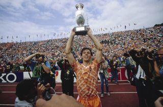 Marco van Basten celebrates with the European Championship trophy after the Netherlands' win against the Soviet Union in the final of Euro 88.