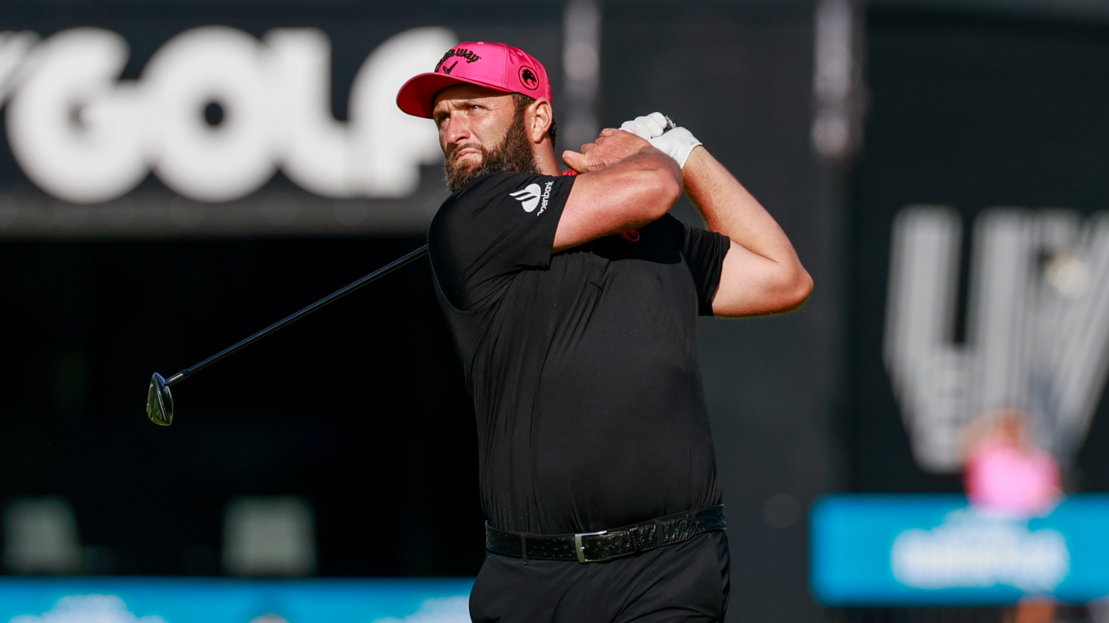 Jon Rahm hits a shot and watches its flight