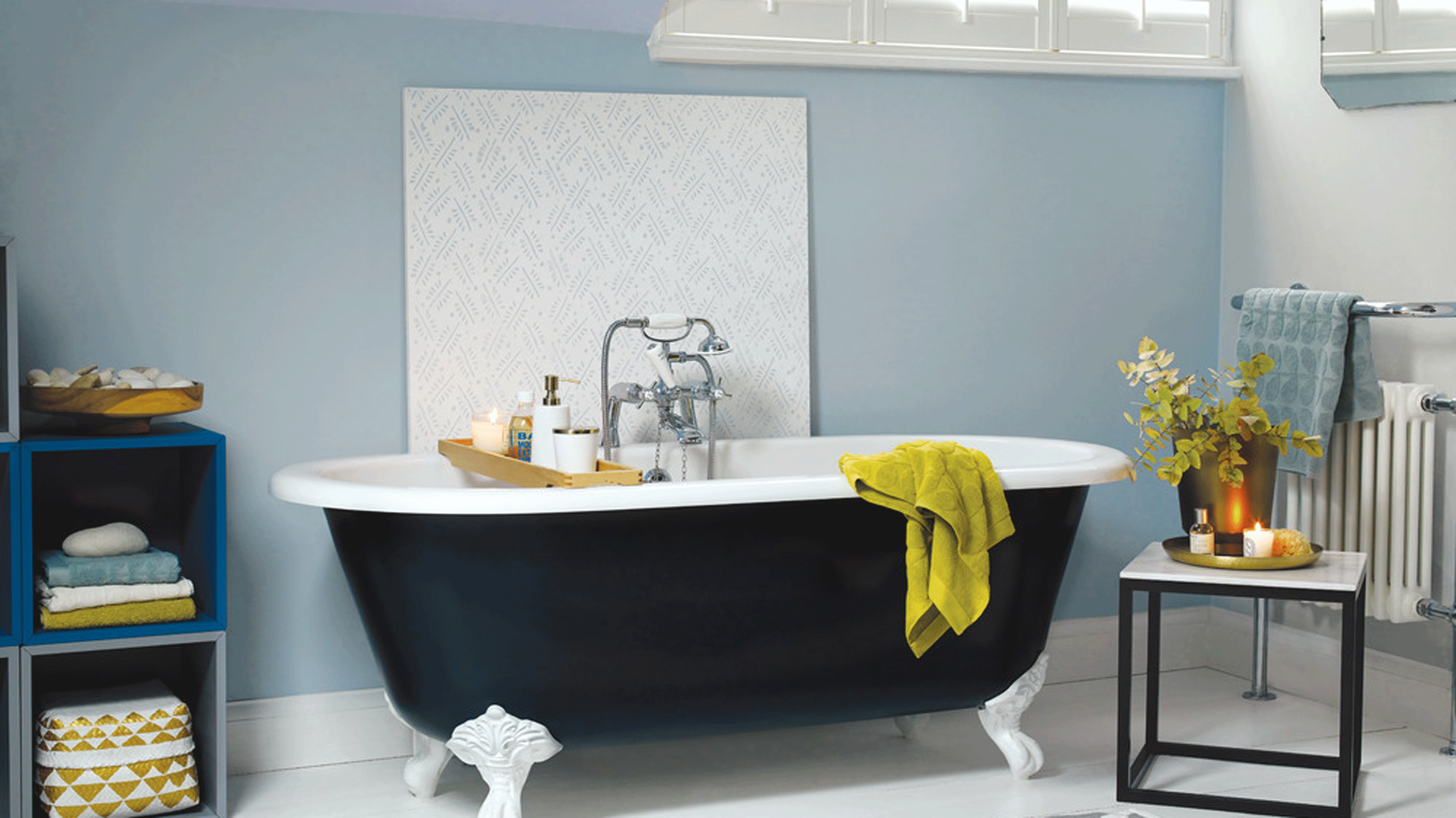 Blue bathroom with white sink and tiled wall
