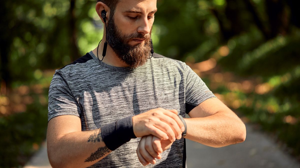 Man checking sports watch outdoors