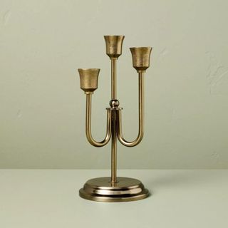 A candlestick with three spots for candles