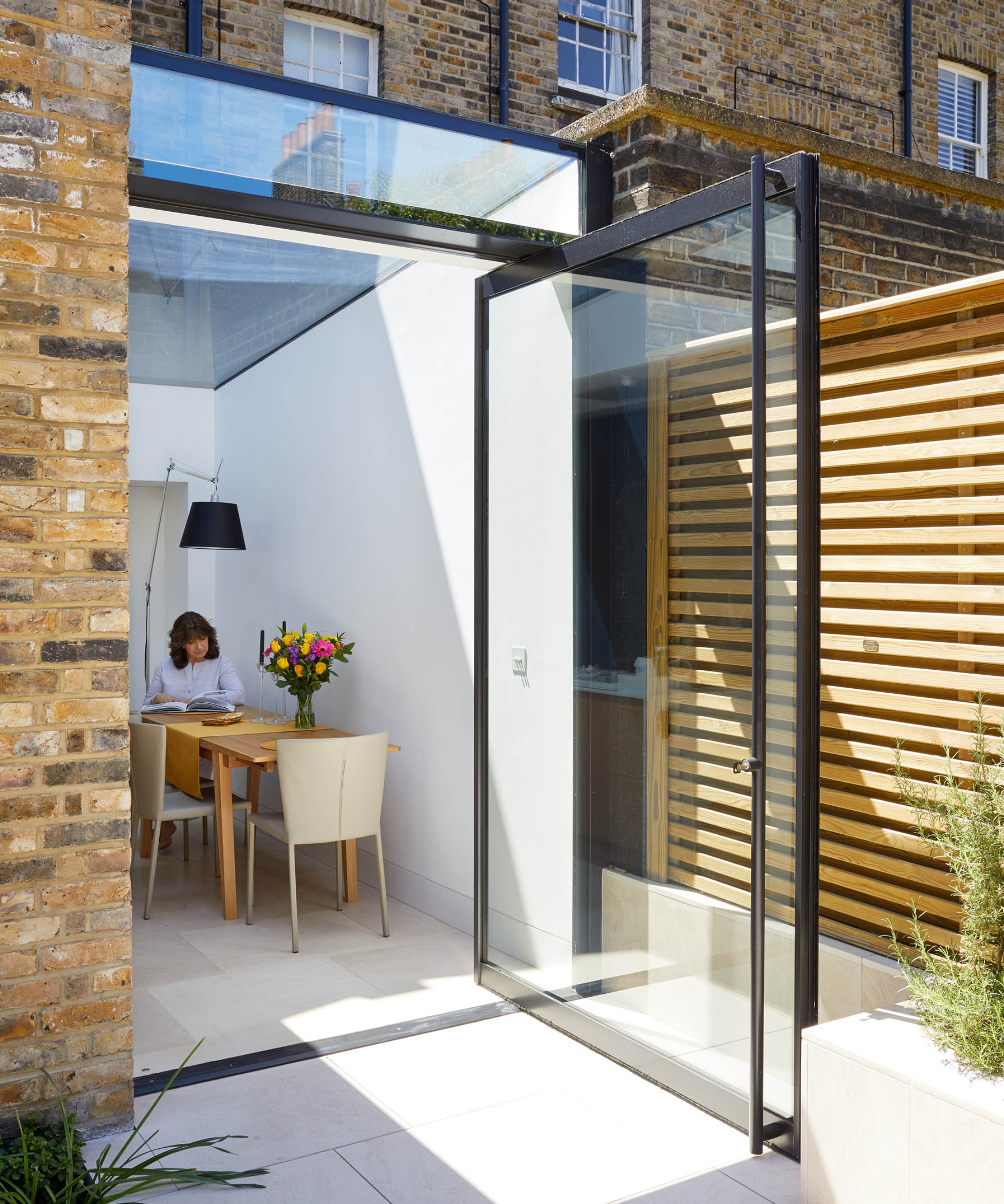 large glass pivot door on glazed section of extension