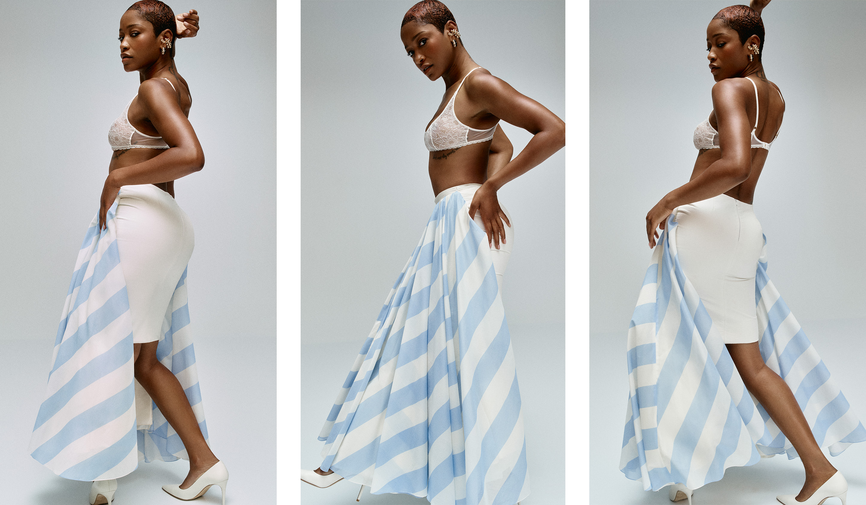Keke Palmer wearing a white bra, white skirt, and a blue and white striped skirt