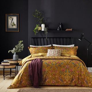 The Rug Seller home decor for autumn william morris bedding in ochre on bed with black wall