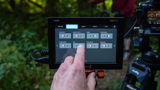 Blackmagic Video Assist 7 12G HDR video monitor with a finger using the touchscreen