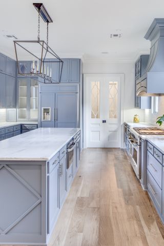 pastel blue kitchen with wood flooring