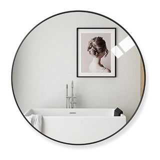 Black round bahtroom mirror on white background